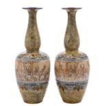 A pair of Doulton Lambeth stoneware vases by Hannah Barlow with slender necks,