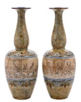 A pair of Doulton Lambeth stoneware vases by Hannah Barlow with slender necks,