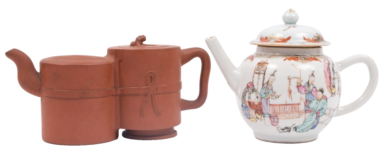 A Chinese Yixing double-chamber teapot and cover and a famille rose teapot and cover the first with