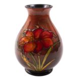 A Walter Moorcroft pottery vase, of oviform, tube lined in the Fresia pattern under flambé glazes,