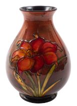 A Walter Moorcroft pottery vase, of oviform, tube lined in the Fresia pattern under flambé glazes,