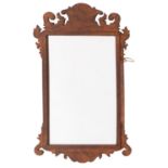 A wall mirror in the Queen Anne style,