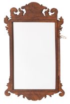 A wall mirror in the Queen Anne style,