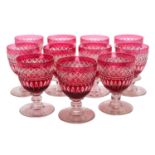 A set of eleven cranberry and clear wine glasses and a part suite of twelve wine glasses,