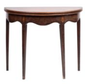 A George III mahogany demi lune tea table; the hinged top with a moulded edge,