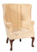 A tub shape wingback armchair in 18th-century style; fully upholstered in ivory fabric,