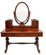 A Victorian walnut dressing table; the superstructure with a central shaped oval swing-frame,