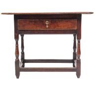 A 17th-century oak rectangular side table; an overhanging moulded top above a drawer,
