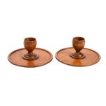 A pair of turned treen eggcups, circa 1900; modelled on stepped circular bases,