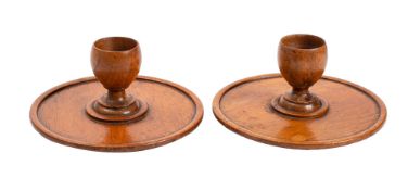 A pair of turned treen eggcups, circa 1900; modelled on stepped circular bases,