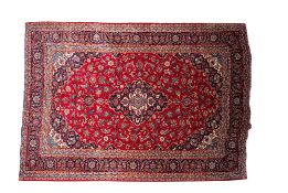 A Kashan carpet, the wine field with a central indigo cartouche pole medallion,