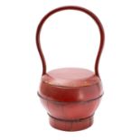 A Chinese red lacquered food basket with high loop handle,