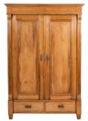 A French pine sectional armoire, late 19th Century, with a moulded cornice,