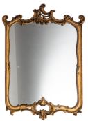 A carved gilt gesso cartouche-shaped mirror in the Rococo taste,