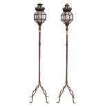 A pair of wrought iron standard lanterns;