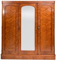 A Victorian pitch pine combination wardrobe, with a rounded cornice,