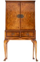 A burr walnut veneer cocktail cabinet, in early 18th century style,