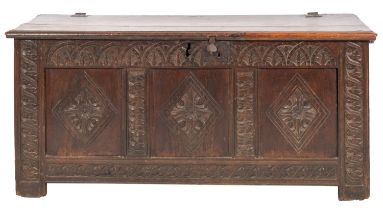 An early 18th century and later carved oak coffer, with a plain hinged moulded top,