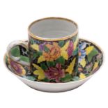 A Chinese famille rose black ground coffee can and saucer enamelled with a 'tobacco leaf' design