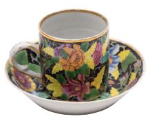 A Chinese famille rose black ground coffee can and saucer enamelled with a 'tobacco leaf' design