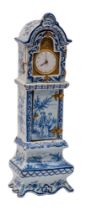 A Dutch blue and white delftware model of a longcase clock containing a late 18th Century watch