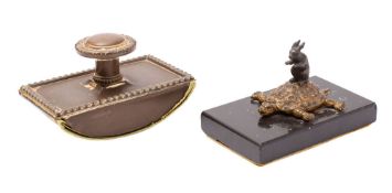 A patinated and parcel gilt metal and marble mounted desk weight,