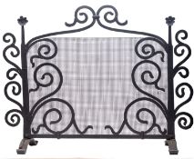 A wrought iron and mesh firescreen in Arts & Crafts style,