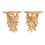 A pair of carved and giltwood wall brackets in 18th century taste,