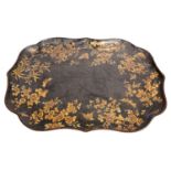 A Victorian parcel gilt black papier-mâché tray, mid 19th century; of cartouche form,