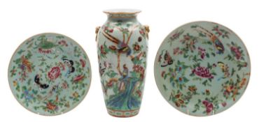 A Chinese Canton famille rose vase and two similar dishes painted with figures, birds, butterflies,