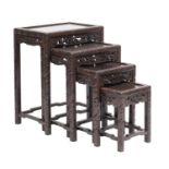 A nest of four Chinese carved and stained hardwood occasional tables,