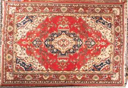 A Sparta carpet, the red cartouche field with a central indigo and ivory cartouche pole medallion,
