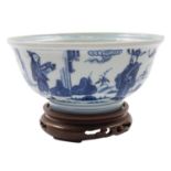 A Chinese blue and white bowl the exterior painted with figures in a garden including an acolyte
