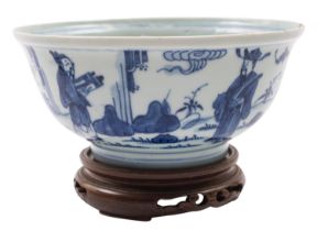 A Chinese blue and white bowl the exterior painted with figures in a garden including an acolyte