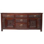 An oak dresser base, early 18th century and later carved; the top,