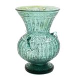 A glass mosque lamp, probably Syrian the pale green body acid etched with calligraphic decoration,