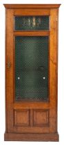 A Victorian oak and glazed gun cabinet, late 19th century; with moulded cornice above the door,