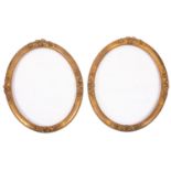 A pair of oval gilt composition picture or mirror frames,