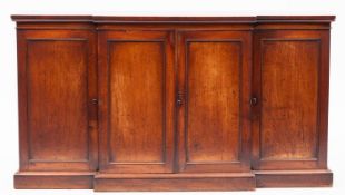A 19th-century mahogany breakfront low side cabinet; enclosed by two pairs of moulded panel doors,