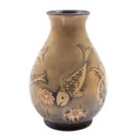 A William Moorcroft pottery vase, of flaring oviform tube lined in the fish pattern,