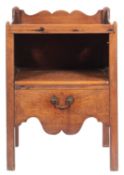 A George III mahogany tray top commode; with a shaped ledge back, open compartment below,