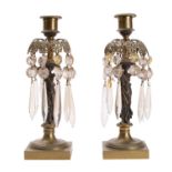 A pair of Regency gilt bronze and glass hung figural lustre candlesticks,