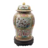 A large Chinese Canton famille rose baluster jar and domed cover painted with panels depicting