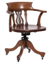 A late Victorian walnut swivel desk office armchair;