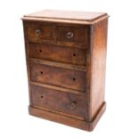 A miniature Victorian walnut chest of drawers, circa 1880; the top with moulded edges,