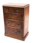 A miniature Victorian walnut chest of drawers, circa 1880; the top with moulded edges,