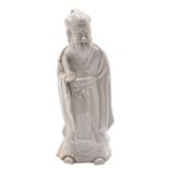 A Chinese blanc-de-chine figure of Shou-Lao wearing flowing robes and holding a scroll,