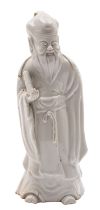 A Chinese blanc-de-chine figure of Shou-Lao wearing flowing robes and holding a scroll,