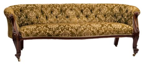 A Victorian carved walnut and upholstered sofa,