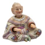 A small Continental porcelain pagoda figure the seated chinaman with nodding head and arms,